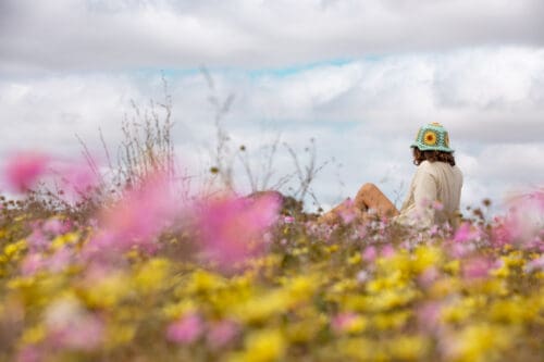 Lady enjoying the wildflowers, near Perenjori